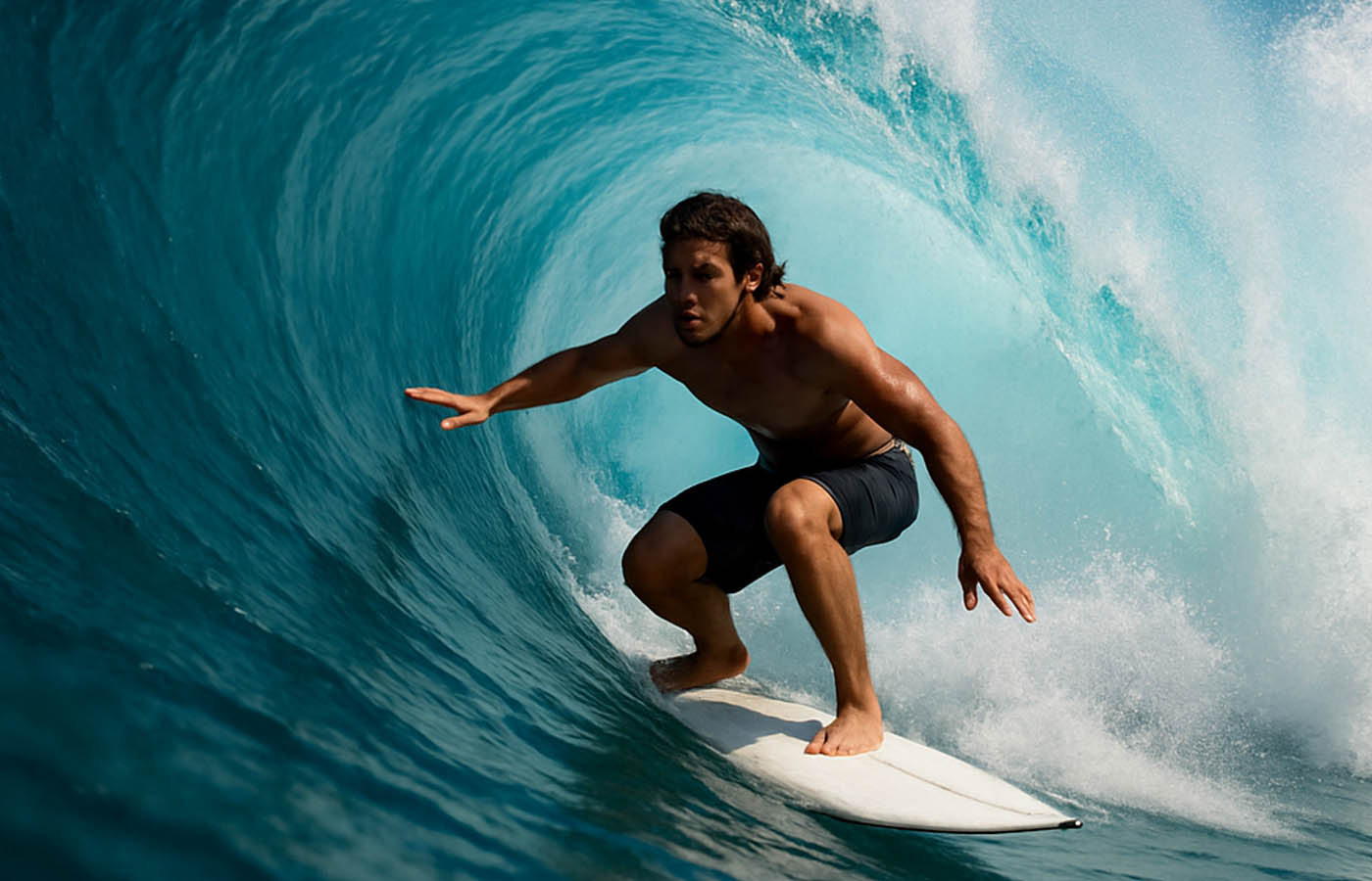 Surfer riding inside a clean blue tube